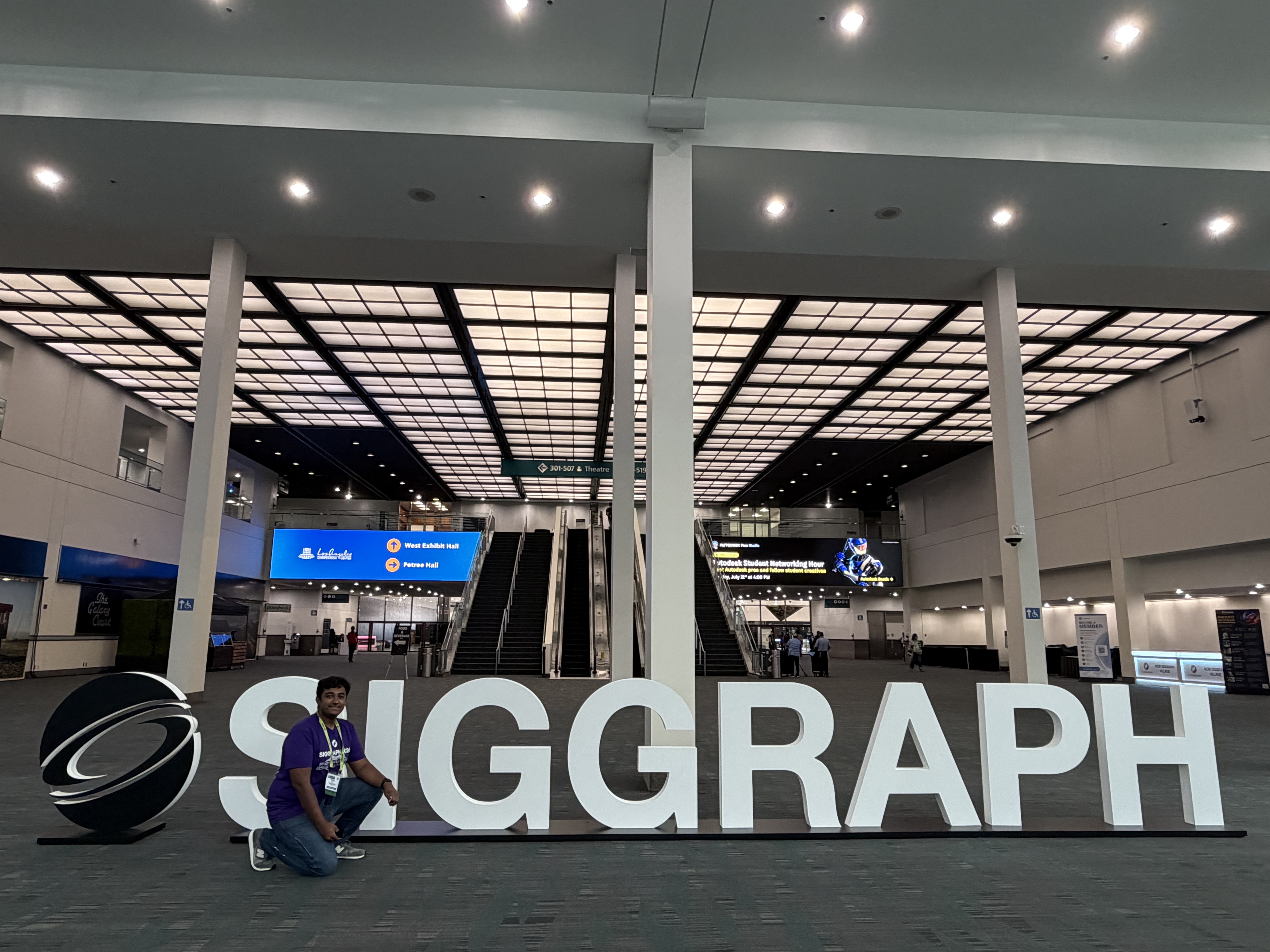 Standing by the SIGGRAPH 2026 sign at the Los Angeles Convention Center